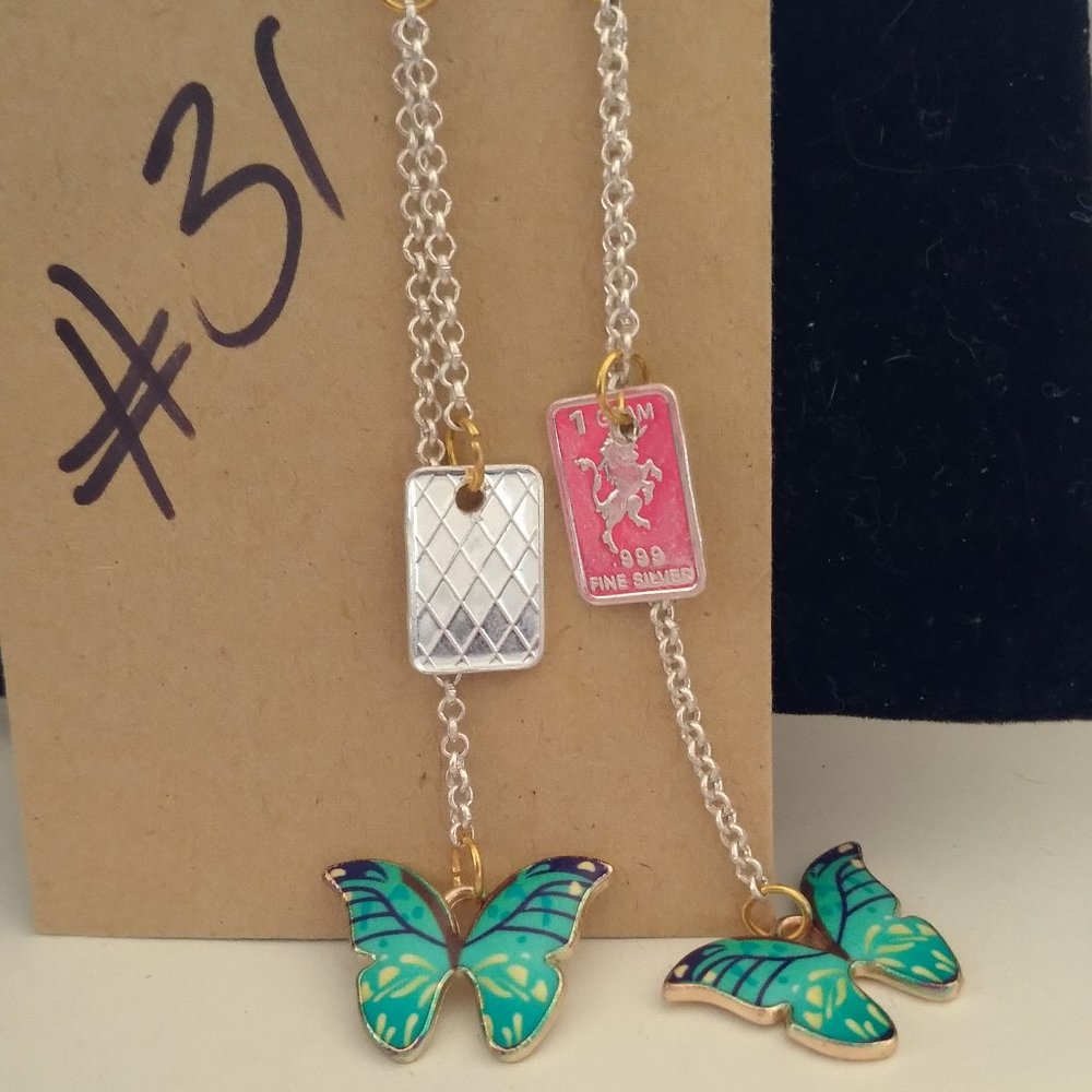 Butterflies and silver bars with long dangler chains in silver tone and gold.
